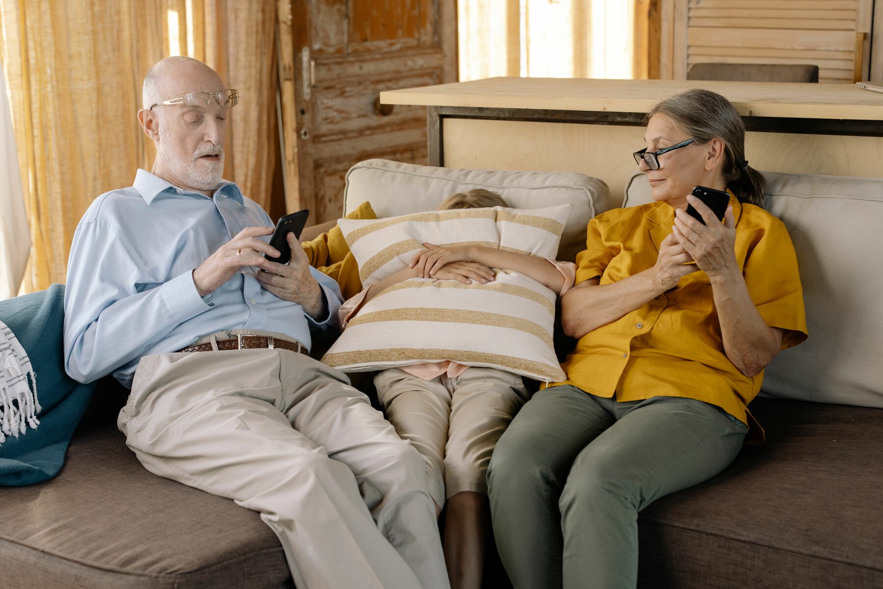 An active man and woman over 55 using smartphones together at home